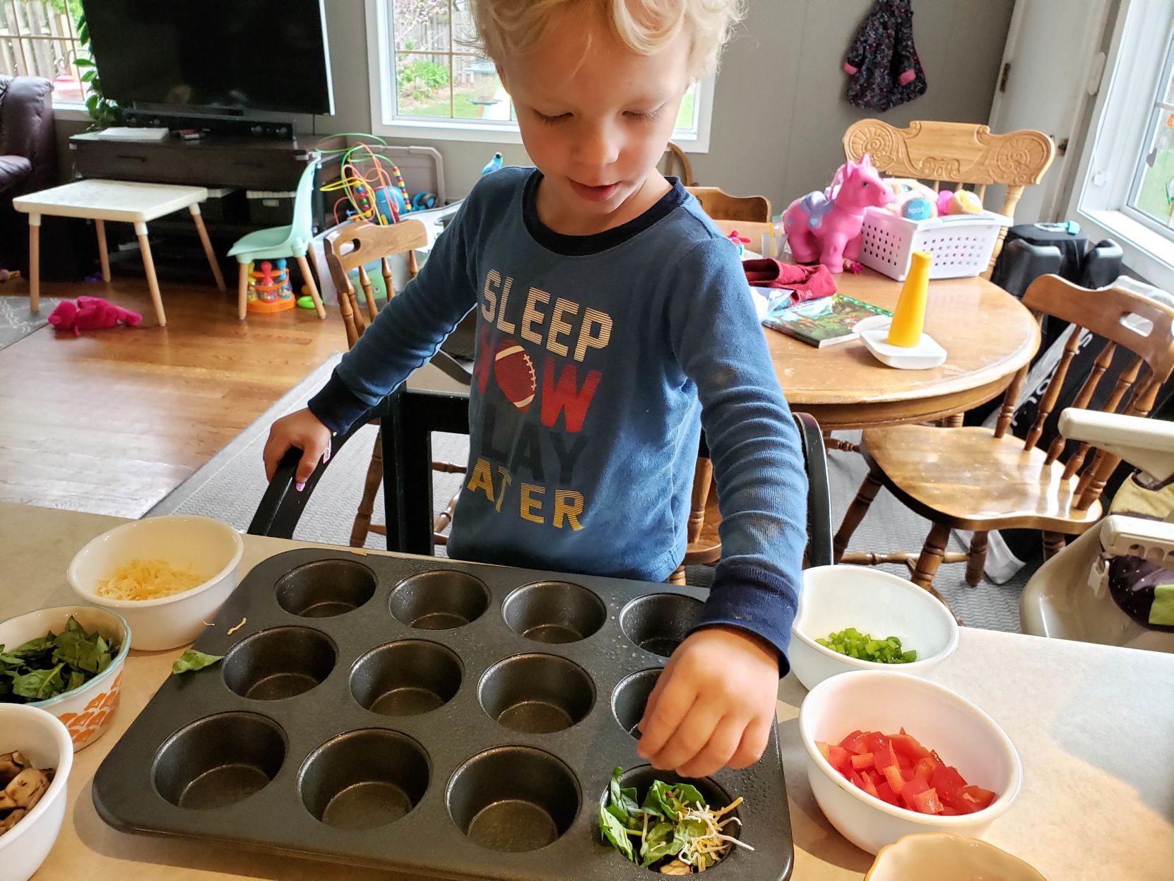 Harrison making omelette muffins